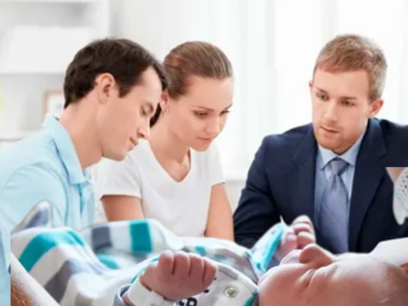 A birth injury lawyer discussing a case with a concerned family in an office setting.